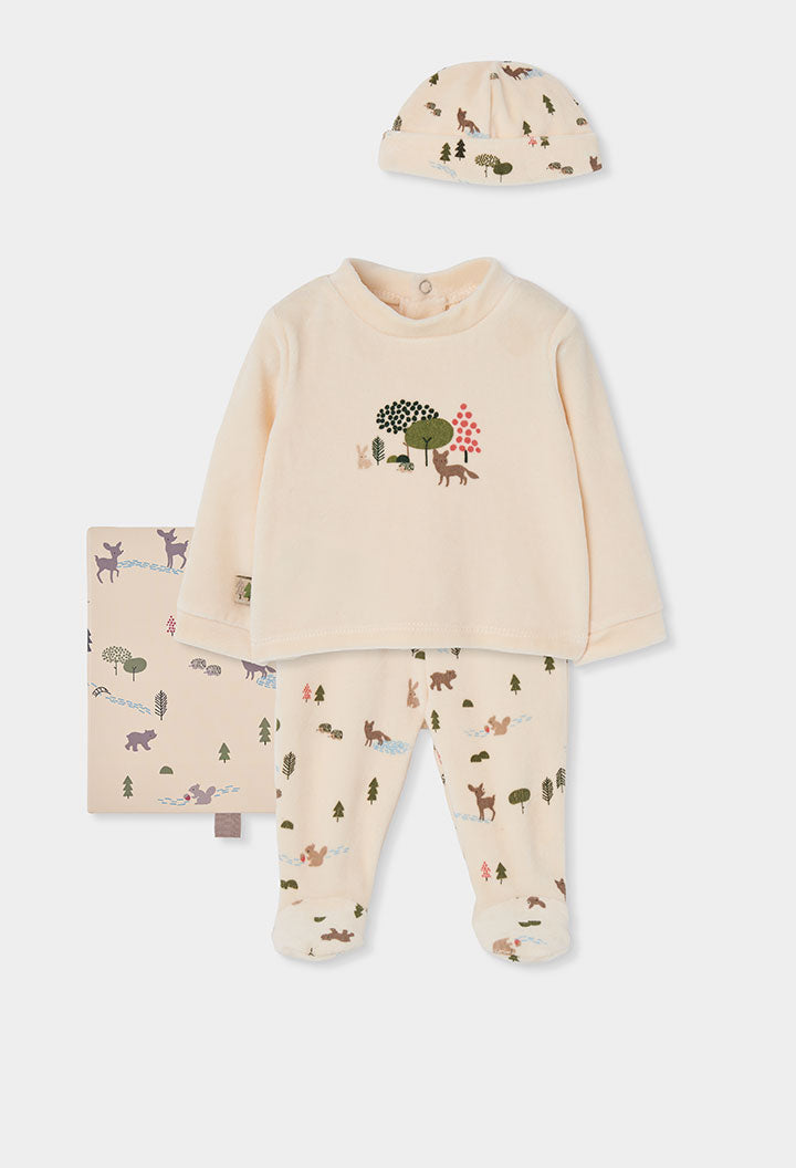 A baby sleepwear set featuring a long-sleeve footed pajama top, matching patterned pajama pants, a matching beanie hat, and a folded blanket, all in a light cream color with forest animal prints and a small tree graphic on the chest.