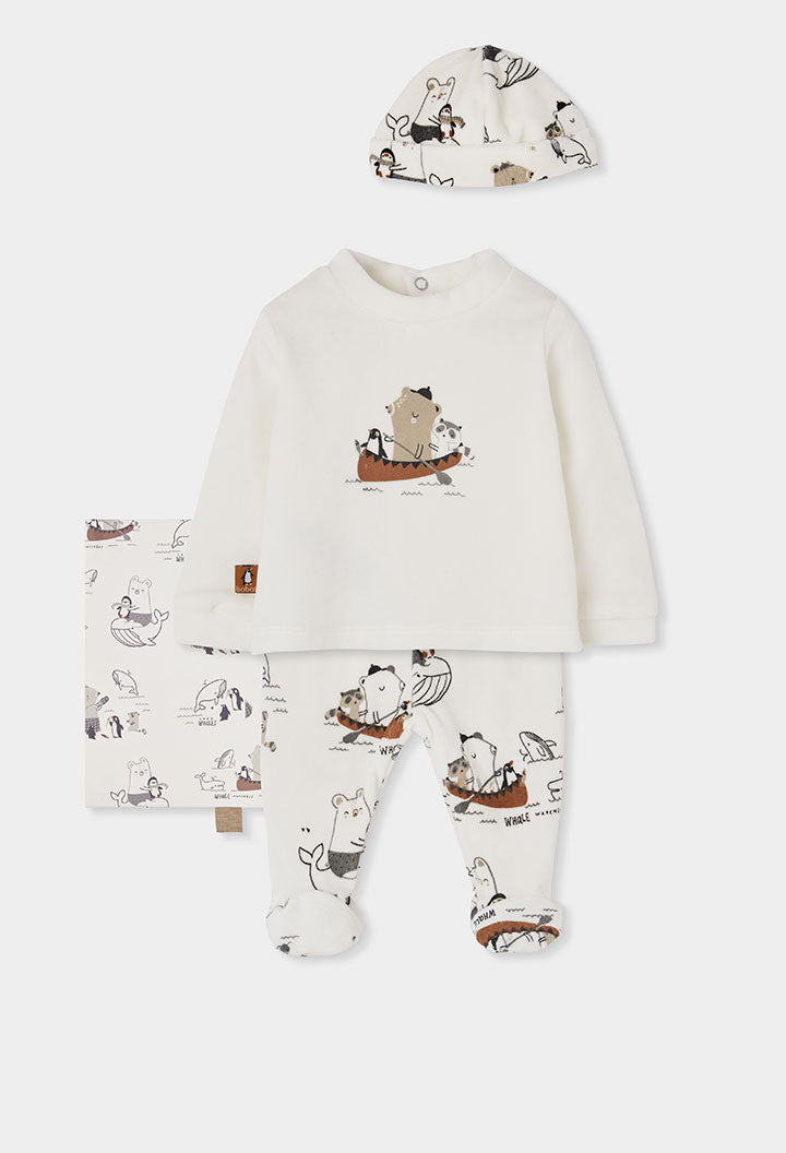 A baby footed one-piece pajama set in off-white, featuring a long-sleeve top and matching pants with a whimsical cartoon animal print, accompanied by a matching bonnet.