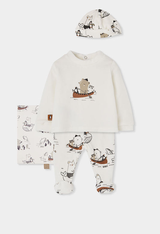 A baby footed one-piece pajama set in off-white, featuring a long-sleeve top and matching pants with a whimsical cartoon animal print, accompanied by a matching bonnet.